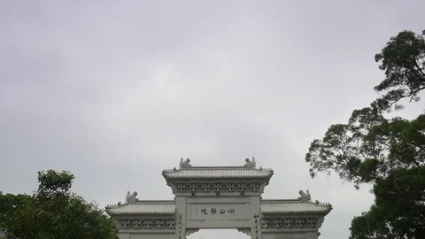 Pan down shot of people walking near Big Buddha statue in Hongkong Stock Footage 91459880