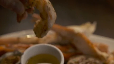 Pan down of shrimp being dipped in butter  動画素材 112660469