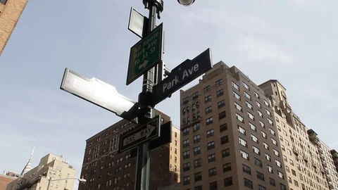 Pan Down from Sign to Homesless Man on Park Avenue Stock Footage 73828057