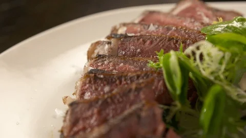 Pan down of sliced medium rare steak  Stock Footage 112660479