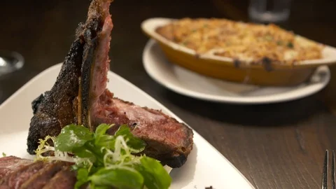 Pan down of sliced tomahawk steak  Stock Footage 112660474