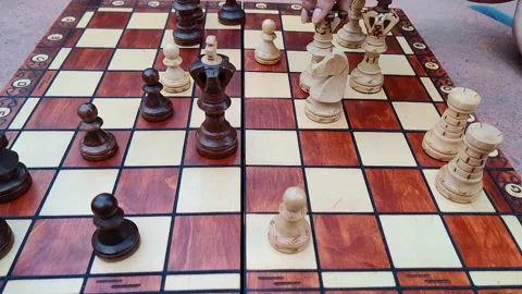 Pan down slow motion shot of chess pieces arranged neatly on a handmade \ Stock Footage 131005418