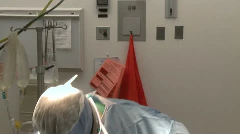 Pan down as surgeon works on patient Stock Footage