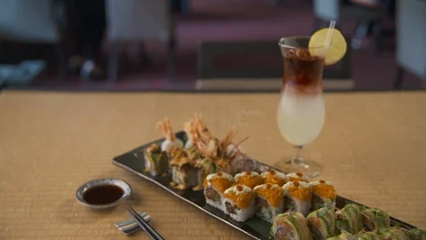 Pan down of sushi with cocktail  動画素材 112576099