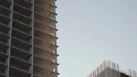 Pan down two skyscrapers under construction Stock Footage 204059258