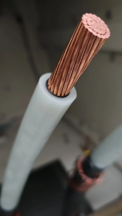Pan down video of a stripped underground electrical power cable showing. Stock-Footage 338355346