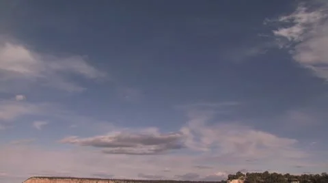 Pan Down View of the Grand Canyon with a Cloudy Blue Sky on The Horizon Stock-Footage 18994918