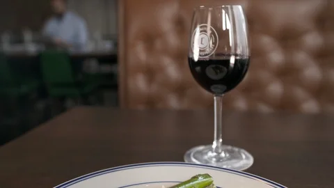 Pan down from wine to steak 動画素材 112575951