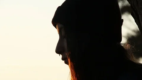 Pan up from drawing to teen's face, looking around Stock Footage 101877005