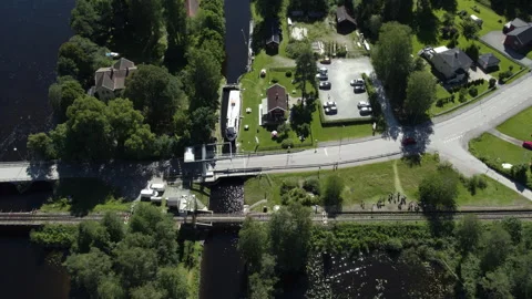 Pan drone shot of train stop and lock at Langbron during the day in Dalsland 動画素材 303076533