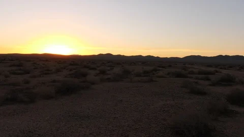 Pan dry desert with distant sunrise. Stock Footage 100981807