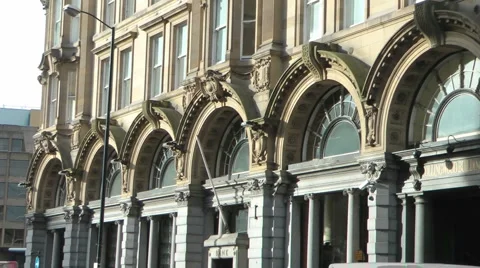 Pan from elegant arched windows of historic stone building to busy street. Stock Footage 1087169