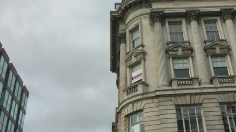 Pan from elegant old historic stone building to more modern office block. Stock Footage 1090529