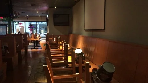 Pan of empty and barren dining area inside restaurant closed during COVID19 Stock Footage 127852836