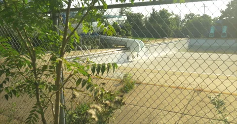 Pan of Empty Pool form behind Fence Stock Footage 42107907