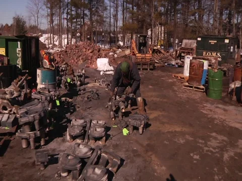 Pan From Exterior Of Foundry To Man Sawing Stock Footage 1089698