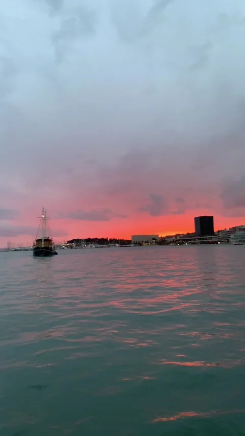 Pan up from feet shot of bay in Split, Croatia with colorful sunset sky Stock Footage 165066247