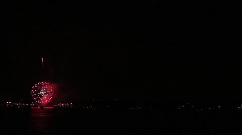 Pan of fireworks exploding over Gulf of Mexico beaches Stock Footage 40648034