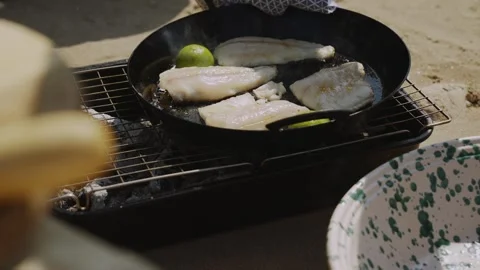 A pan of fish is being cooked on a grill Stock Footage 298247701