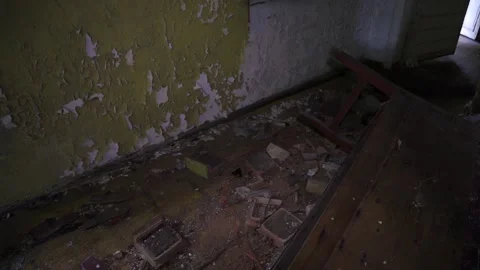 A pan from a floor to a broken down fireplace in the abandon house Stock Footage 142328170