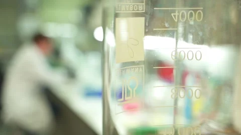 Pan focus in a laboratory with a scientist working Stock Footage 145867481