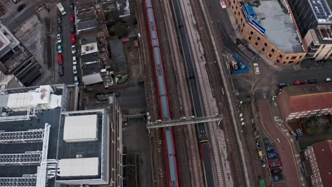 Pan up follow drone shot of Train pulling into London Waterloo station Stock Footage 149095680