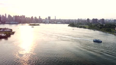 Pan Follow Tracking: Speeding Ferry Boat Under RFK Bridge Sunset Aerial 4K Drone Stock Footage 165246529