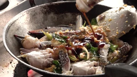 A pan of food is being cooked with a spoon in it Stock Footage 289316694