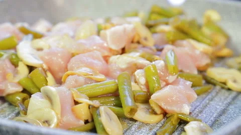 Pan-fried chicken with beans and mushrooms. Time laps Stock Footage 111668250