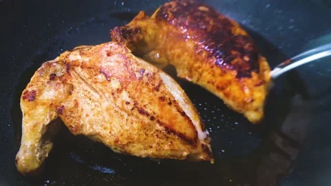 Pan fried chicken breast fillets Stock Footage