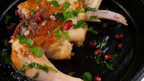 Pan fried chicken Tabaka style, with garnet seeds and parsley Stock Footage 83165551