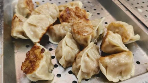 Pan Fried Dumplings with Golden Crispy Edges at a Taiwanese Breakfast Shop Stock Footage 343590178
