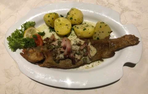 Pan fried trout with potatoes Stock Photos