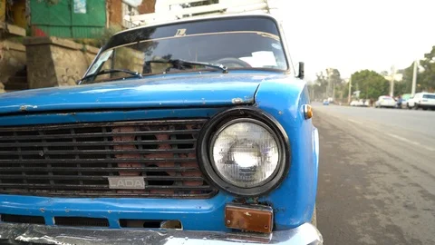 Pan from front of a Lada cab to a Toyota Bus, in Addis Ababa, Ethiopia Video stock 87208741