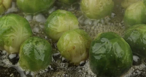 Pan frying brussels sprouts closeup Stock Footage 155504475