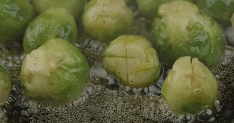 Pan frying brussels sprouts closeup Stock Footage 159147963