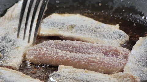 Pan frying the herring fish with the bread crumbs.close-up.4K UHD Stock Footage 145818654