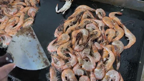 Pan-frying large king prawns. Preparing langoustines. Close-up. Top view. Bold Stock Footage 333995378