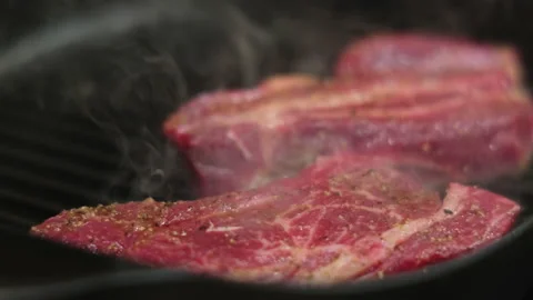 Pan frying meat steaks Stock Footage 132290572