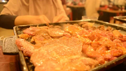 A pan full of meat in cooking process for All You Can Eat stock footage Stock Footage 275168458