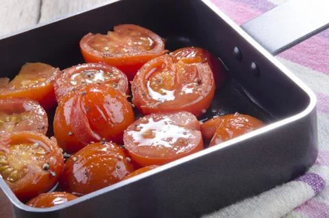 Pan with grilled cherry tomatoes Stock Photos