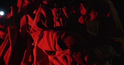 Pan up from ground to two firemen, bathed in red emergency light. Stock Footage 69216199