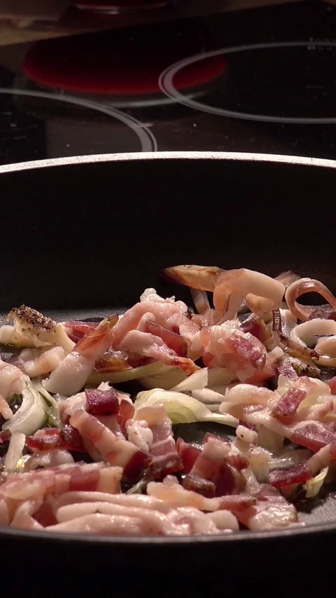 Pan with guanciale (like bacon) almost ready for pasta all'amatriciana, vertical Stock Footage 284965289