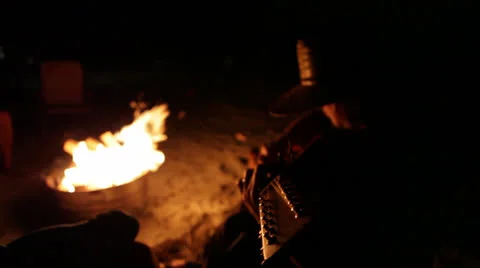 Pan from guitar to firecircle and back Stock Footage 24637603