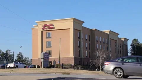 Pan of Hampton Inn and Suites and traffic distant view Stock Footage 149224364