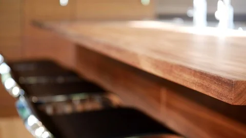 Pan of hand-crafted, black walnut countertop in modern kitchen. Stock Footage 98013756