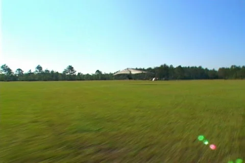 Pan of Hang Glider Taking-off Across the Sun Video stock 141462