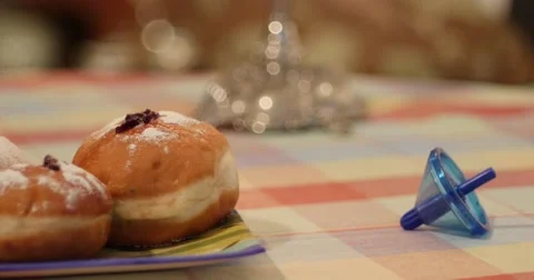 Pan from Hanukkah Donuts to static Dreidel Video stock 56984976