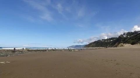 Pan of Hill Beach Rocks and Ocean Stock Footage 87927310