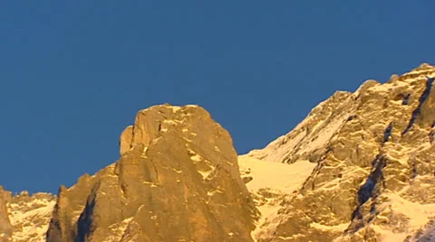 Pan + hold  evening sunlight on Schreckhorn, a mountain in the Swiss Alps Stock Footage 34387916